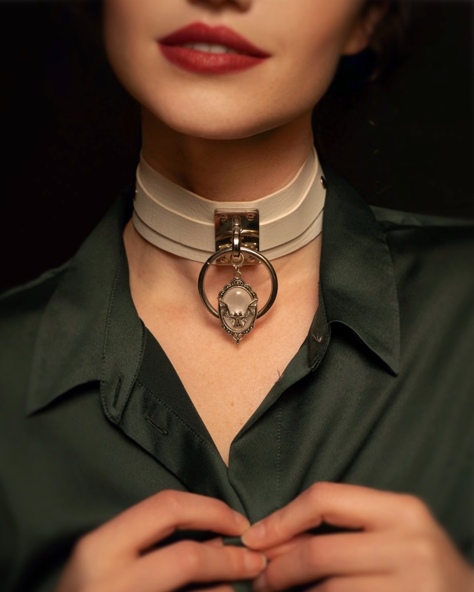 a woman wearing a choker with a skull on it